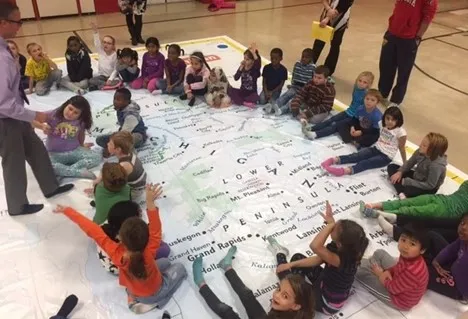 People on giant map of michigan